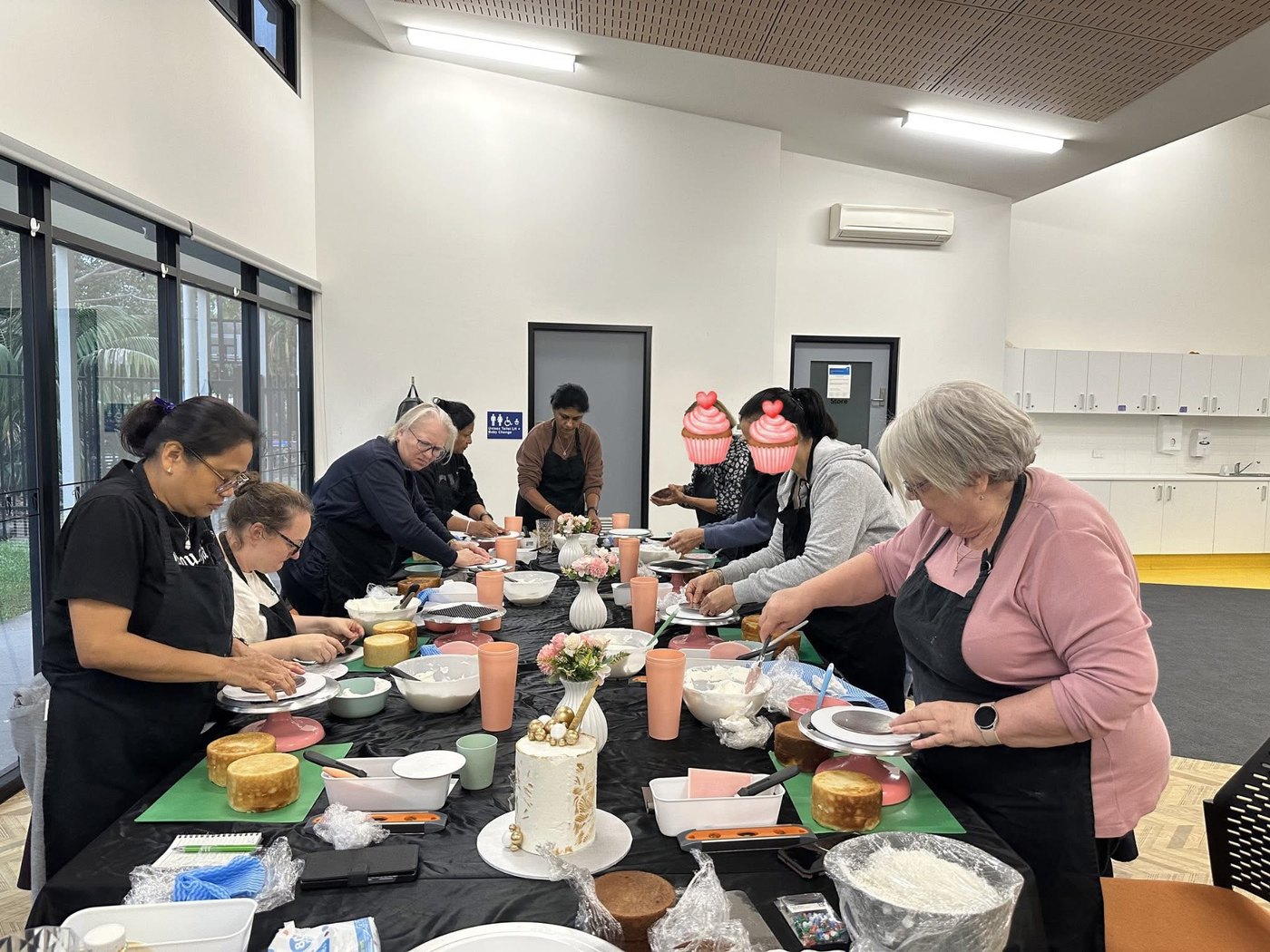 Students learning cake decorating techniques