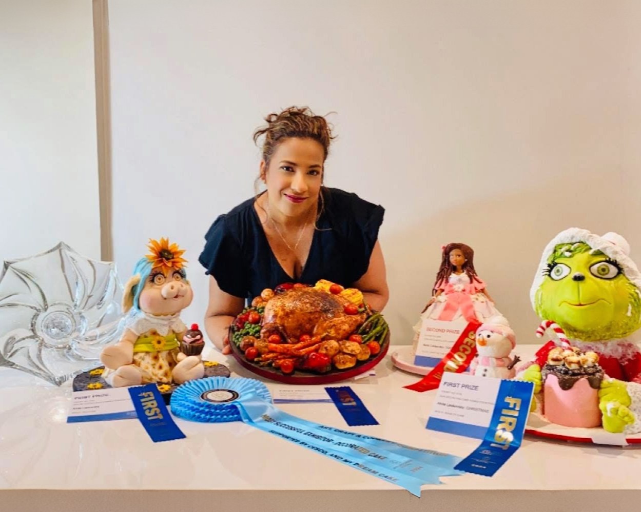 Anita with award-winning cake work and ribbons